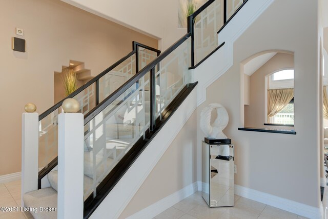 stairway featuring tile patterned floors