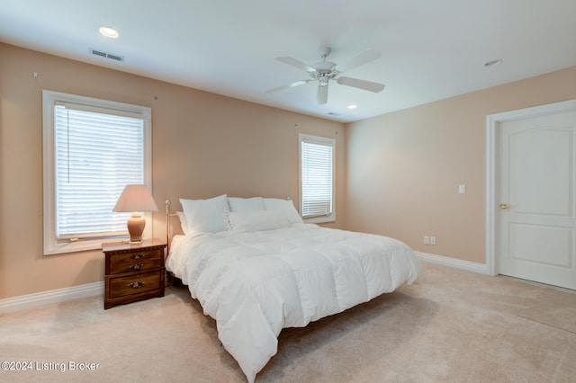 bedroom with ceiling fan and light carpet