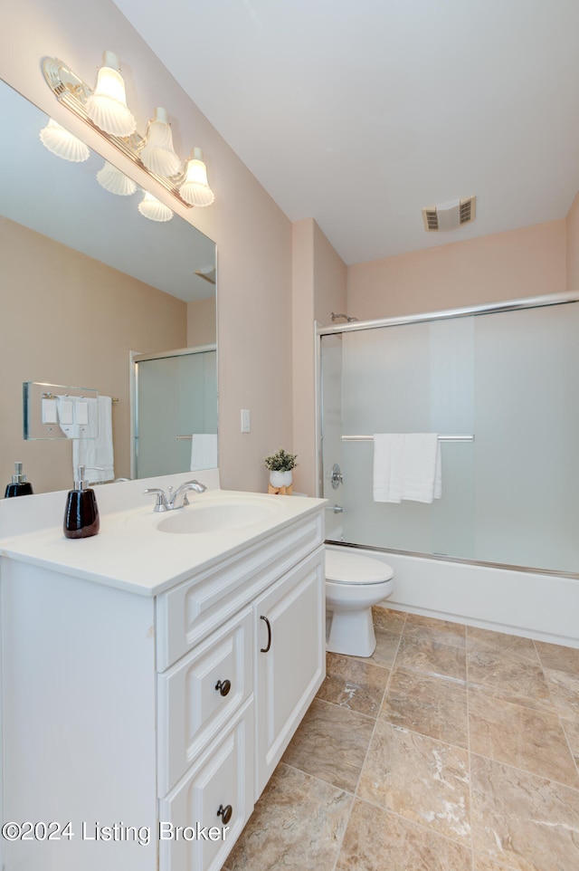 full bathroom featuring tile patterned floors, toilet, vanity, and enclosed tub / shower combo