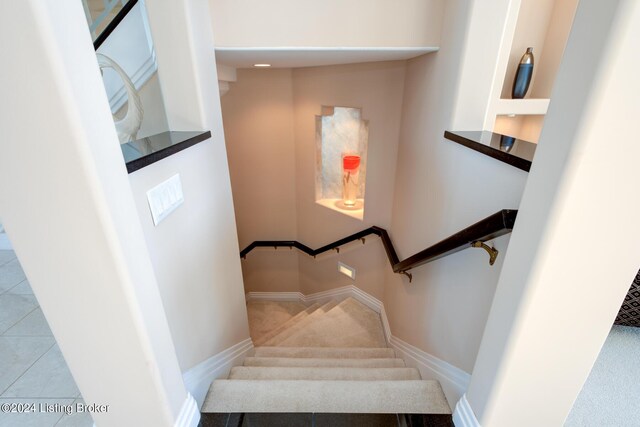 stairway with tile patterned flooring