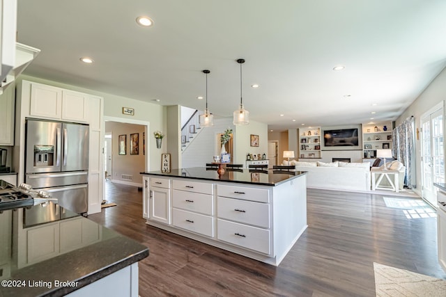 kitchen featuring dark wood-style flooring, a fireplace, hanging light fixtures, white cabinetry, and stainless steel fridge with ice dispenser