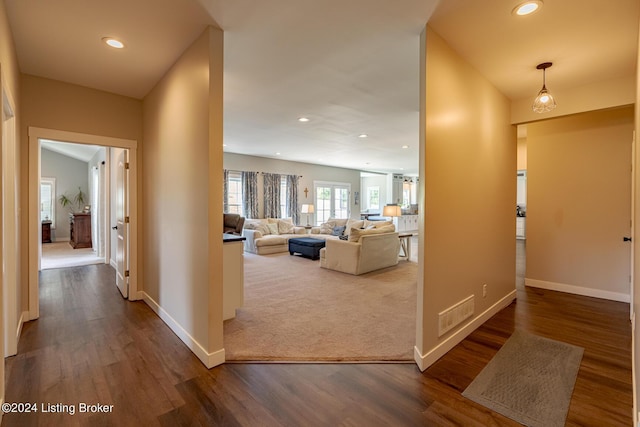 corridor featuring baseboards, dark wood-style flooring, and recessed lighting