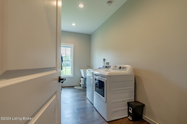 washroom featuring recessed lighting, laundry area, separate washer and dryer, dark wood-type flooring, and a sink