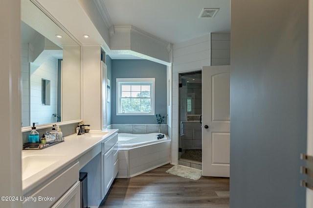 full bath with a garden tub, visible vents, a stall shower, a sink, and wood finished floors