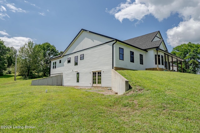 rear view of property featuring a yard