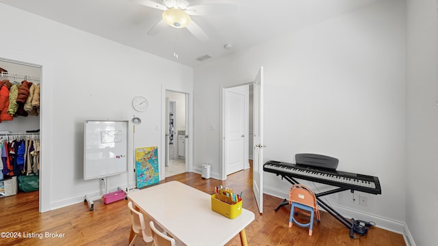 playroom with ceiling fan and hardwood / wood-style floors