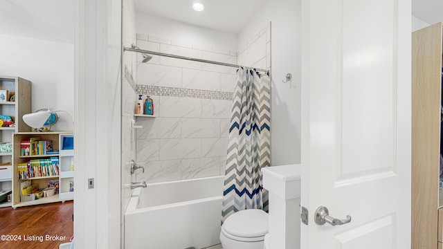 bathroom with toilet, wood-type flooring, and shower / tub combo with curtain