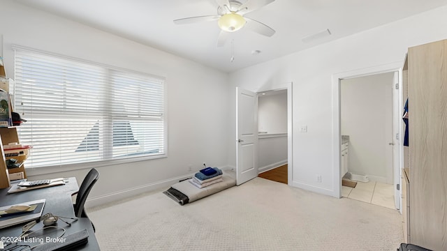 home office featuring light colored carpet and ceiling fan