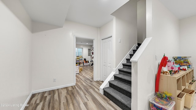 stairway with hardwood / wood-style flooring