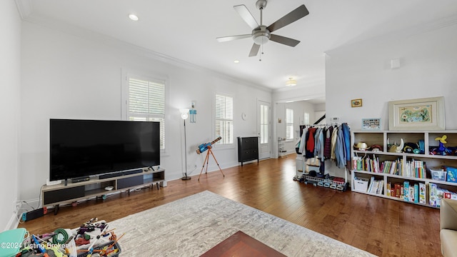 living room with ceiling fan, hardwood / wood-style flooring, and crown molding