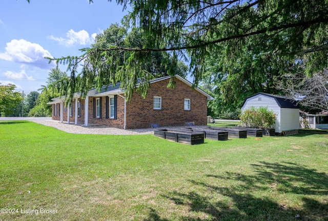 view of home's exterior featuring an outdoor structure and a lawn