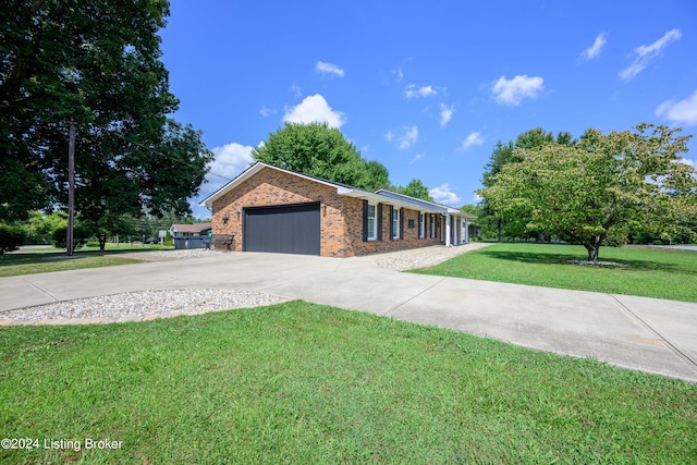 ranch-style home featuring a front yard and a garage