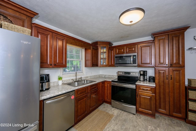 kitchen featuring sink, stainless steel appliances, and light tile patterned floors