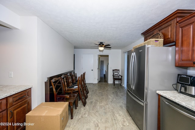 kitchen with dishwasher, ceiling fan, and light wood-type flooring