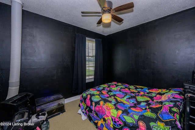 bedroom featuring ceiling fan, a textured ceiling, and carpet flooring