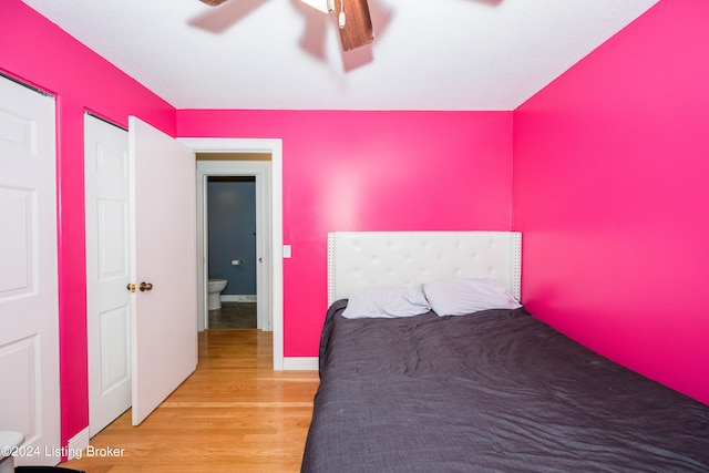 unfurnished bedroom featuring ceiling fan, light hardwood / wood-style floors, and ensuite bath