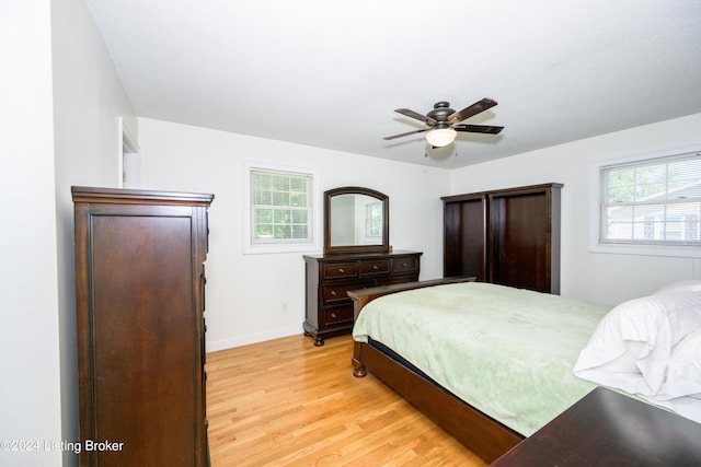 bedroom with light hardwood / wood-style flooring and ceiling fan