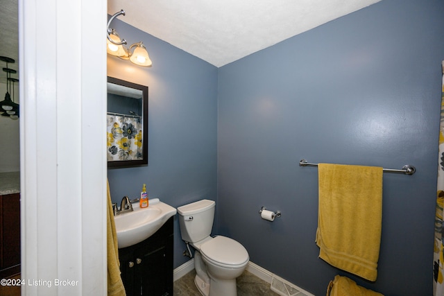 bathroom with tile patterned floors, toilet, and vanity