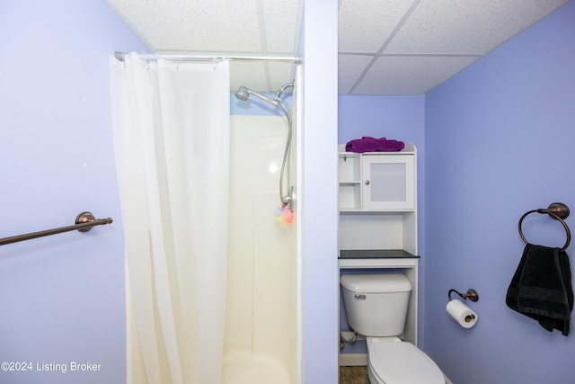 bathroom featuring a paneled ceiling and toilet