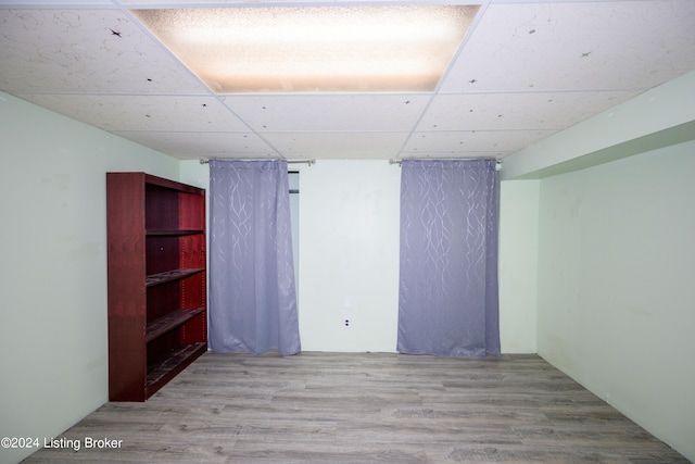 empty room featuring hardwood / wood-style flooring and a paneled ceiling