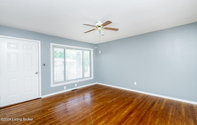 empty room with ceiling fan and hardwood / wood-style flooring