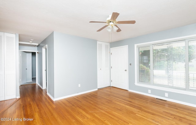 spare room with ceiling fan and wood-type flooring