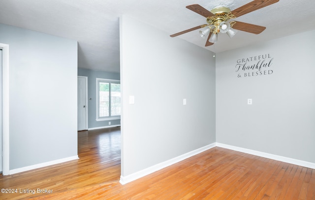 empty room featuring ceiling fan and hardwood / wood-style flooring