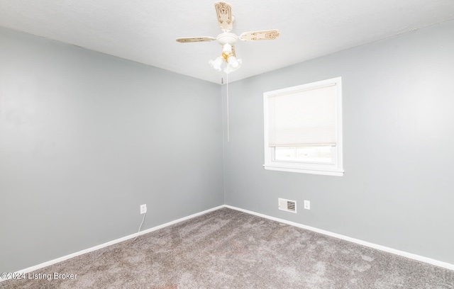 spare room featuring ceiling fan and carpet floors