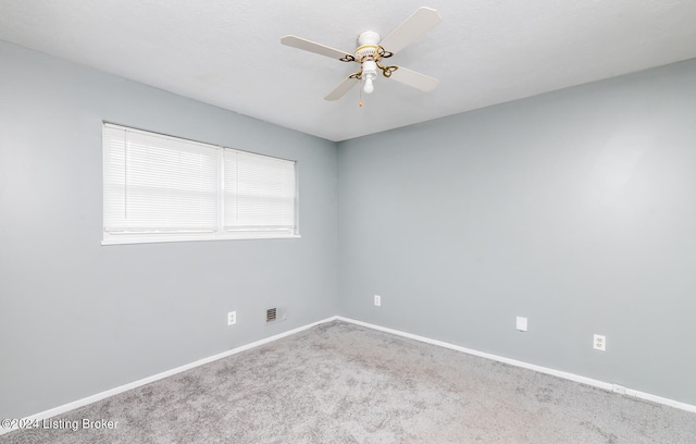 spare room with ceiling fan and carpet floors