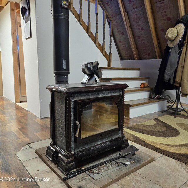 interior details featuring hardwood / wood-style floors and a wood stove