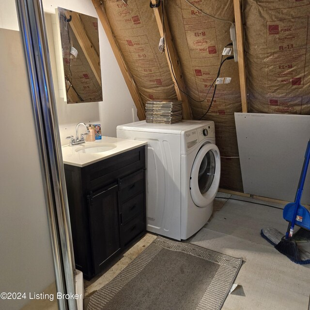 laundry area featuring sink and washer / dryer