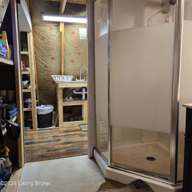 bathroom featuring concrete floors and a shower with door