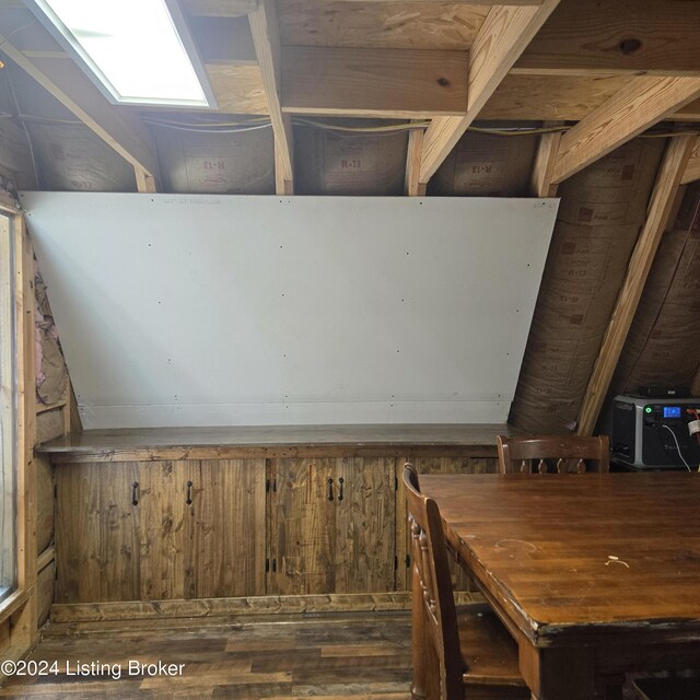 room details with hardwood / wood-style flooring and a skylight