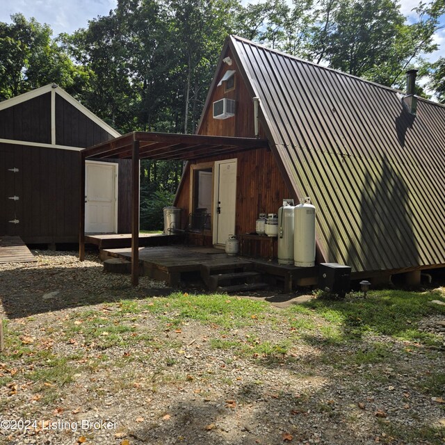 rear view of house with an outdoor structure