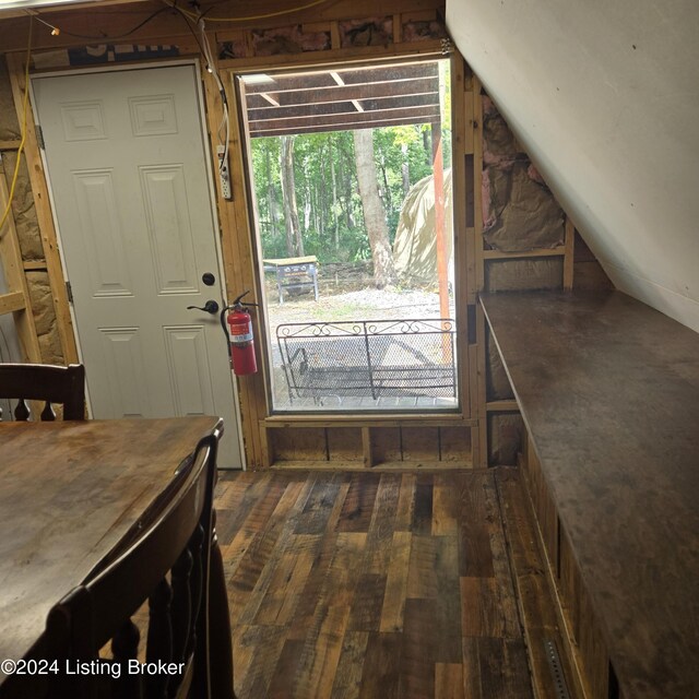 interior space with dark hardwood / wood-style flooring and lofted ceiling