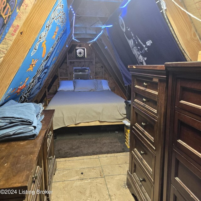 bedroom featuring lofted ceiling and light tile patterned floors