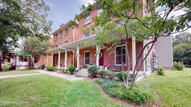 view of front of house featuring covered porch and a front yard