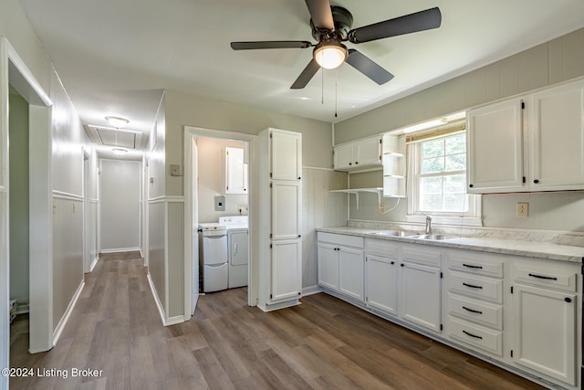 kitchen featuring light wood-type flooring, separate washer and dryer, white cabinetry, and ceiling fan