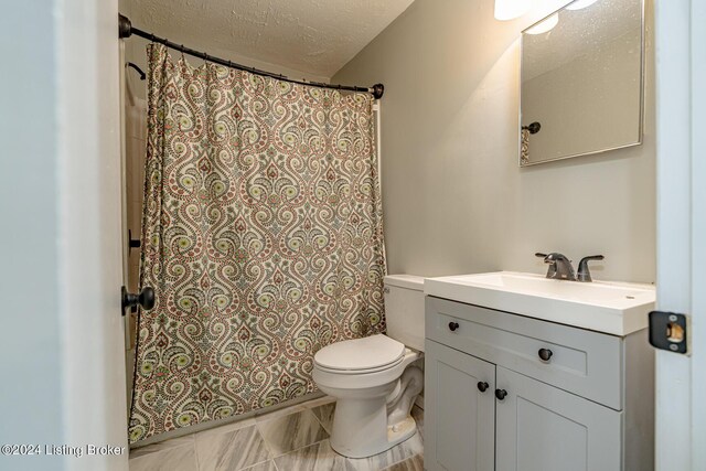 bathroom with a textured ceiling, walk in shower, vanity, and toilet