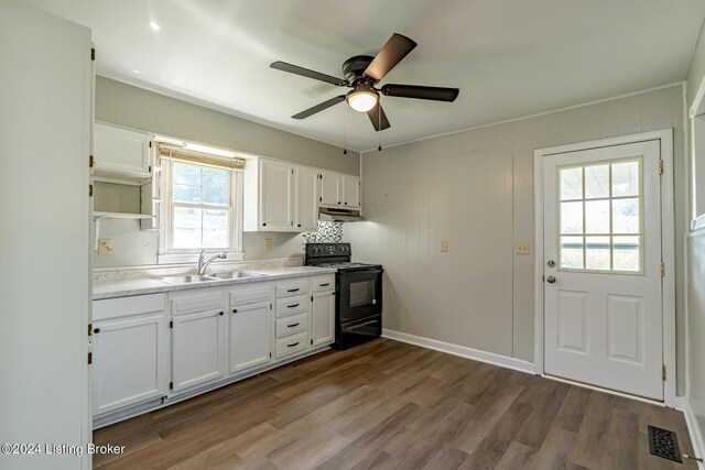 kitchen featuring white cabinets, ceiling fan, black electric range oven, and sink