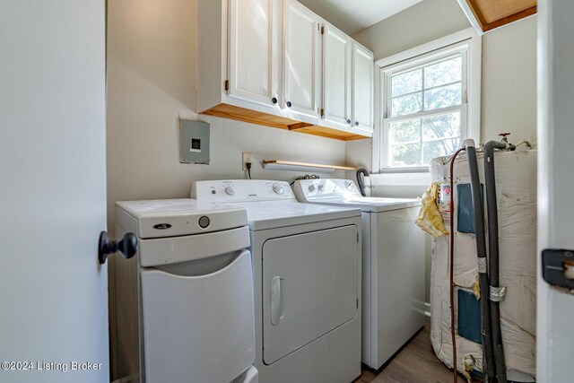 laundry room with cabinets, hardwood / wood-style floors, and washer and dryer