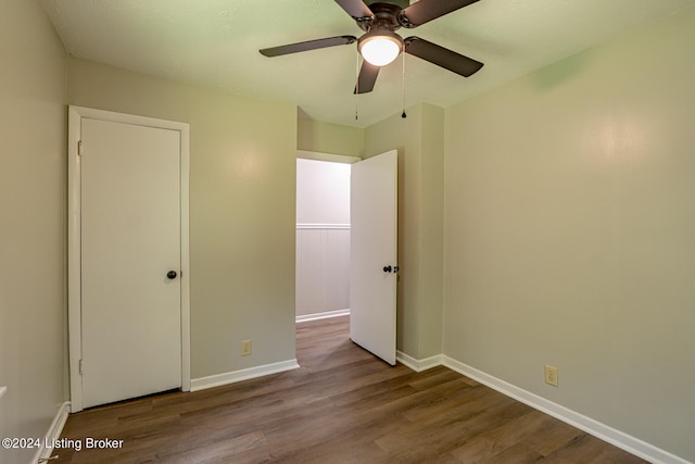 unfurnished bedroom with ceiling fan and hardwood / wood-style floors