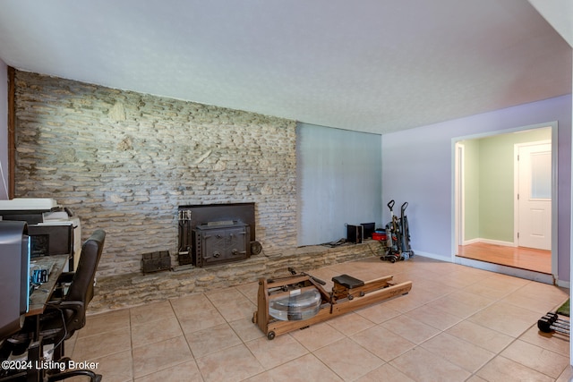 tiled living room featuring a wood stove