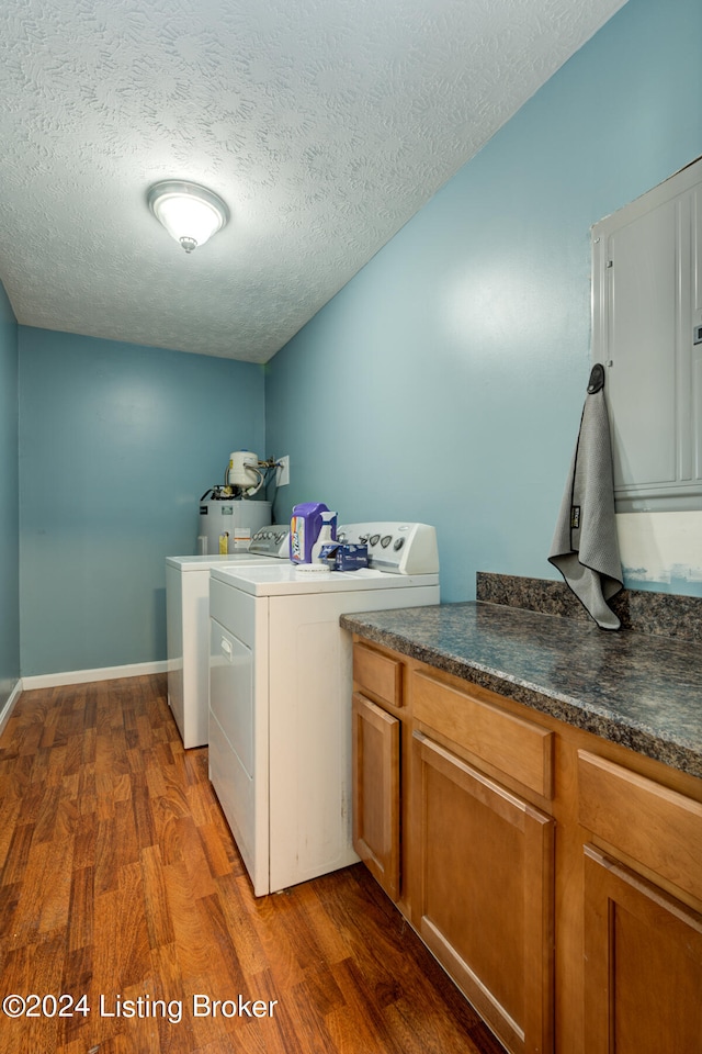 clothes washing area featuring hardwood / wood-style flooring, washer and clothes dryer, and a textured ceiling