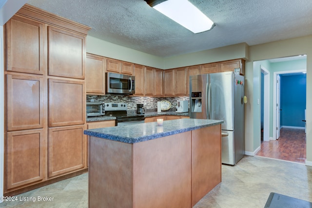 kitchen with decorative backsplash, light wood-type flooring, a textured ceiling, a center island, and stainless steel appliances