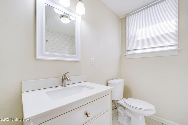 bathroom featuring tile patterned floors, vanity, and toilet