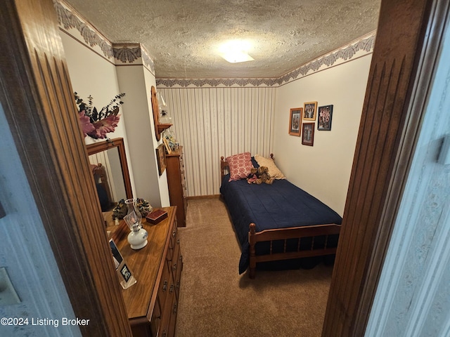 carpeted bedroom featuring a textured ceiling