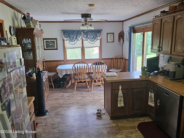 kitchen featuring dishwasher, kitchen peninsula, ceiling fan, ornamental molding, and a textured ceiling