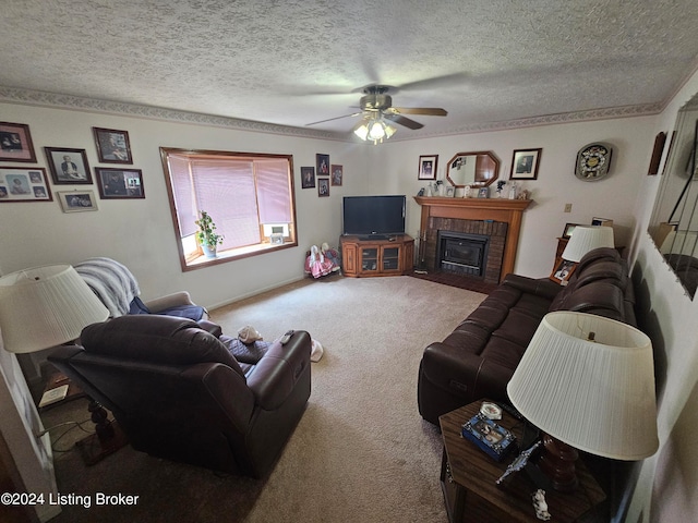 living room featuring a textured ceiling, a brick fireplace, ceiling fan, and carpet floors