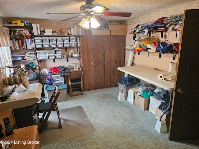 office with a textured ceiling, carpet, and ceiling fan